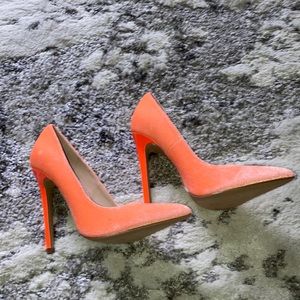 Faux Velvet pump. The color is Orange.  The heel height is about 4.5